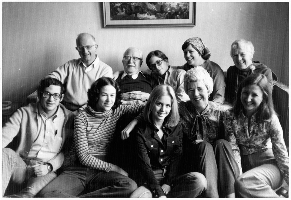 R.S. Mendelsohn , TG Remer, Harry Remer, Ruth Lockshin, and Annetta Remer sitting on a couch in front of Martin Lockshin, Sally Mendelsohn, Abby Remer, Rita Mendelsohn, and Pat Remer, in NYC on Thanksgiving 1977. Photographed by Michael Remer.