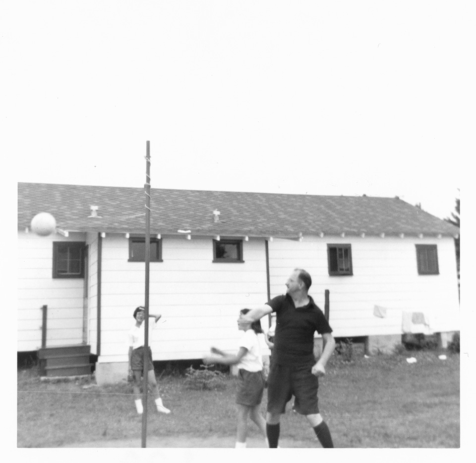 R.S. Mendelsohn hits the ball, as he and 2 [possibly 3?] girls play tetherball at Camp Marimeta in Eagle River, Wisconsin (where R.S. Mendelsohn was doctor from 1956-1967).
